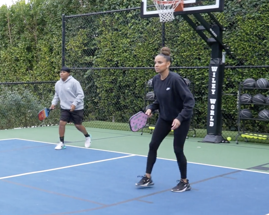 Two people playing paddle tennis